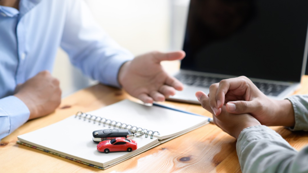 person discussing auto financing in a dealership