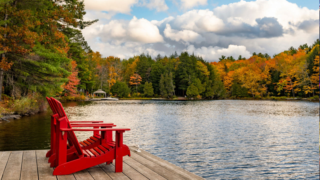 big red chair on the docks by lake Muskoka