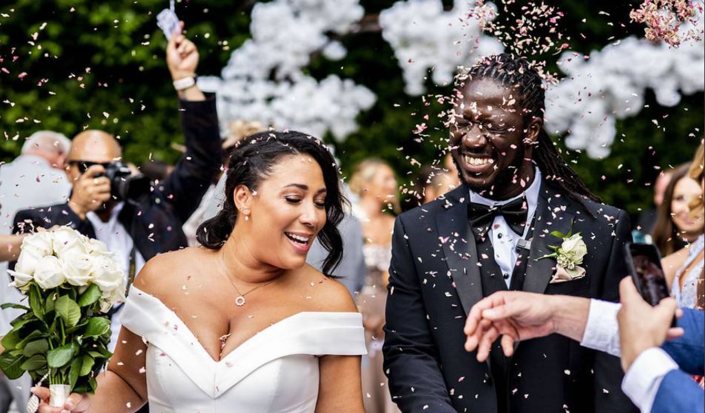 young couple showered with confetti during their wedding